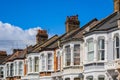 A row of typical British terraced houses in London with overhead cable lines Royalty Free Stock Photo