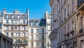 Row of typical French residential buildings in Batignolles under the blue sky