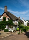 Typical quaint, ancient white washed thatched roof cottages in Dunster, Somerset Royalty Free Stock Photo