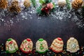 A row of ugly Christmas sweater cookies with sprinkles and decorations above. Royalty Free Stock Photo