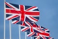 Row of Union Jack British Flags on Flagpoles Royalty Free Stock Photo