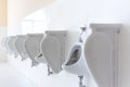 Row of urinal toilet blocks in men public toile Royalty Free Stock Photo
