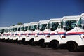 US postal service trucks parked in a line. Royalty Free Stock Photo