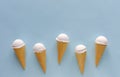 Row of vanilla ice cream cones on blue Royalty Free Stock Photo