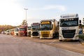 Row of various company trucks parked at a truck overnight parking somwehere along the E30 highway. Germany - June 14, 2019