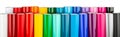 Row of various rainbow colored vinyl car wrapping or plotter cutting sticker plastic foil film rolls isolated white wide panorama Royalty Free Stock Photo