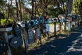 A row of various shaped and sized mail boxes by the side of the road in rural New Zealand Royalty Free Stock Photo
