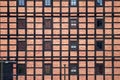 a row of vertical and horizontal windows in a red brick and timber frame wall Royalty Free Stock Photo