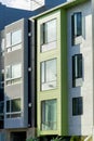 Row of vertical town homes in San Francisco California with modern decorative house facades green and gray Royalty Free Stock Photo