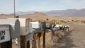 Row of vintage drop boxes on road intersection, arid Arisona desert, USA. Postal retro mailboxes on roadside of tourist Route 66. Royalty Free Stock Photo