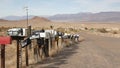 Row of vintage drop boxes on road intersection, arid Arisona desert, USA. Postal retro mailboxes on roadside of tourist Route 66. Royalty Free Stock Photo