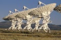 Row of VLA Very Large Array radio telescope dishes Royalty Free Stock Photo