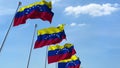 Row of waving flags of Venezuela agaist blue sky, 3D rendering