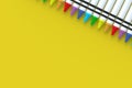 Row of wax crayons on yellow background. Colorful pencils. Back to school concept. Preschool education