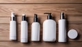 A row of white bottles of lotion on a wooden table Royalty Free Stock Photo