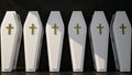 row of white coffins stand