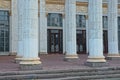 A row of white concrete columns near an old building Royalty Free Stock Photo