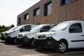 Row white delivery service van small trucks park front of factory warehouse distribution plant Royalty Free Stock Photo