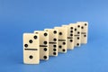 Row of white domino tiles on blue background Royalty Free Stock Photo