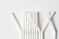 Row of white flexible plastic straws for beverages