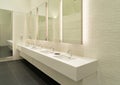 Row of white modern marble ceramic wash basin in public toilet, restroom in restaurant or hotel or shopping mall, interior Royalty Free Stock Photo