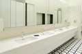 Row of white modern marble ceramic wash basin in public toilet, restroom in restaurant or hotel or shopping mall, interior