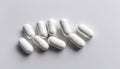 A row of white pills on a white background