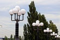 Row with white round shades on street lights in the street Royalty Free Stock Photo