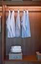 Row of white shirts and black pants hanging in wardrobe Royalty Free Stock Photo