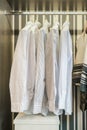 Row of white shirts hanging in retro style background wardrobe Royalty Free Stock Photo