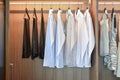 Row of white shirts hanging in wardrobe Royalty Free Stock Photo