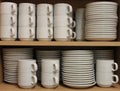 A Row White Tableware sat on a shelf Royalty Free Stock Photo