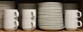 A Row White Tableware sat on a shelf Royalty Free Stock Photo