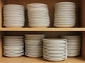 A Row White Tableware sat on a shelf Royalty Free Stock Photo