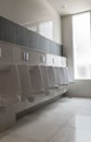 Row of white urinals ceramic`s men public toilets or restroom Royalty Free Stock Photo