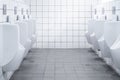 Row of white urinals in men public bathroom toilet with white tiles wall Royalty Free Stock Photo