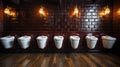 Row of white urinals in a row on brick wall background. Men public toilet