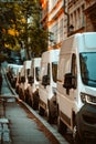 A row of white vans parked on the side of a street. Generative AI Royalty Free Stock Photo