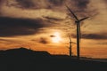 A row of windmills along the coast during golden hour in Bangui, Ilocos Norte, Philippines. Sustainable and renewable energy.