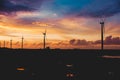 A row of windmills during a dramatic sundown in Bangui, Ilocos Norte, Philippines. Sustainable and renewable energy in Asia