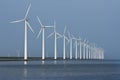 Row of windmills, mirrored in the Dutch sea