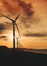 A row of windmills near the beach during sunset in Bangui, Ilocos Norte, Philippines. Sustainable and renewable energy. Royalty Free Stock Photo