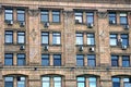 A row of windows on a brick brown house wall Royalty Free Stock Photo