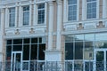 A row of windows on a brown concrete wall with gray columns Royalty Free Stock Photo