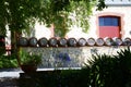 Row of wine barrels in cottage style winery gardens. Royalty Free Stock Photo