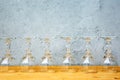 Row of wine glasses on wooden table with grey background Royalty Free Stock Photo