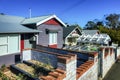 Row of wooden apartment houses with brick fences Royalty Free Stock Photo