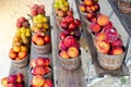 Row of wooden baskets full of fresh picked plums and peaches on shelves display at roadside market stand in Santa Rosa, Destin, Royalty Free Stock Photo