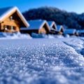 A row of wooden cabins in the snow with a blue sky in the background Royalty Free Stock Photo