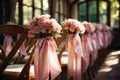 A row of wooden chairs covered in pink bows. Royalty Free Stock Photo